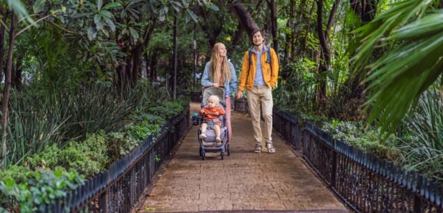A,Married,Couple,And,Their,Son,In,A,Stroller,Exploring
