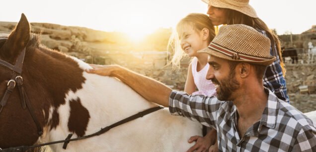 Happy,Mother,Daughter,And,Father,Family,Having,Fun,Riding,Horse