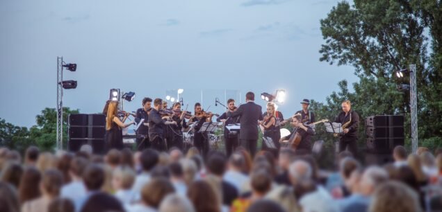 Orchestra,Performing,Live,Concert,For,Audience,Under,Blue,Sky